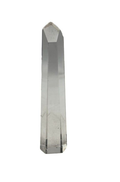 Clear Quartz Crystal Obelisk Point Sculpture: Clear quartz crystal obelisk point sculpture featuring a faceted top. The piece measures approximately 6 inches in height. Transparent and smoothly polished with a flat base for upright display. No ma