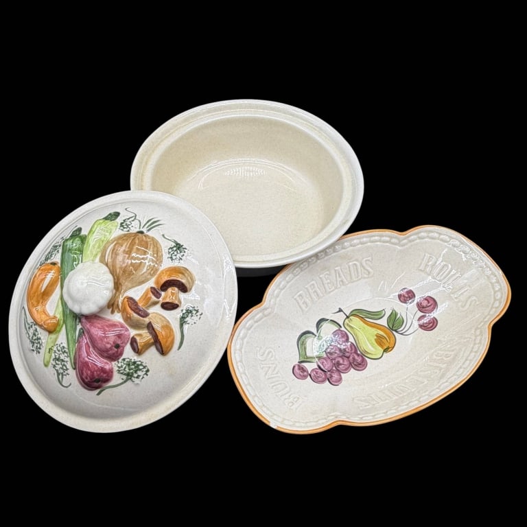 FRUIT PLATTER & COVERED VEGETABLE BOWL 11": Charming ceramic serving set comprising a bread platter and a covered vegetable serving bowl, with colorful fruit and vegetable decoration against a speckled cream glaze. The shaped platter features p