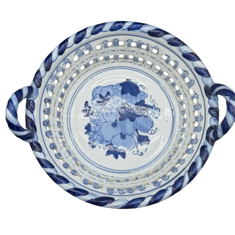 BLUE & WHITE PIERCED CERAMIC BASKET BOWL 11": Decorative Chinese blue and white ceramic basket bowl featuring cobalt blue fruit and foliate decoration, including a central cluster of grapes and leaves. Two rows of rectangular pierced openings cre