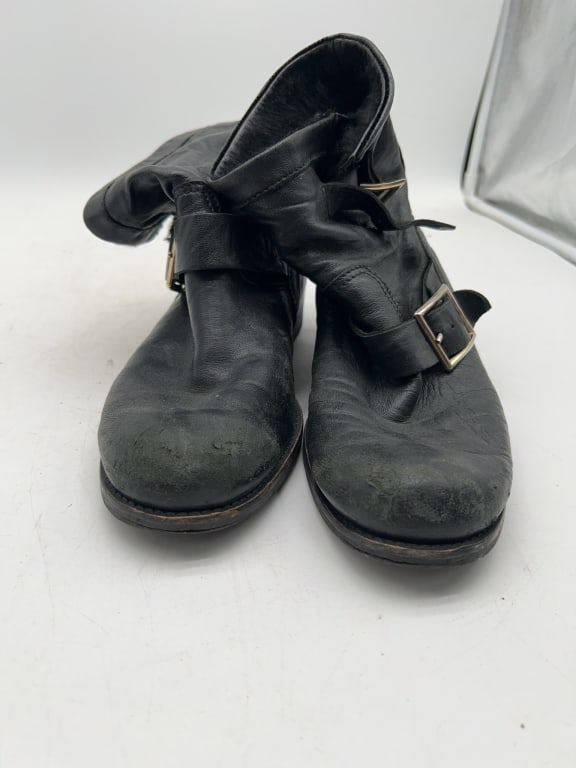 Jimmy Choo Black Leather Buckle Boots 38.5: Jimmy Choo boots in black leather with double gold-tone buckles. Size 38.5, made in Italy. Boots show signs of wear including scuffing, primarily at toes and heels. Lugged rubber soles. | HOME WEARHOU