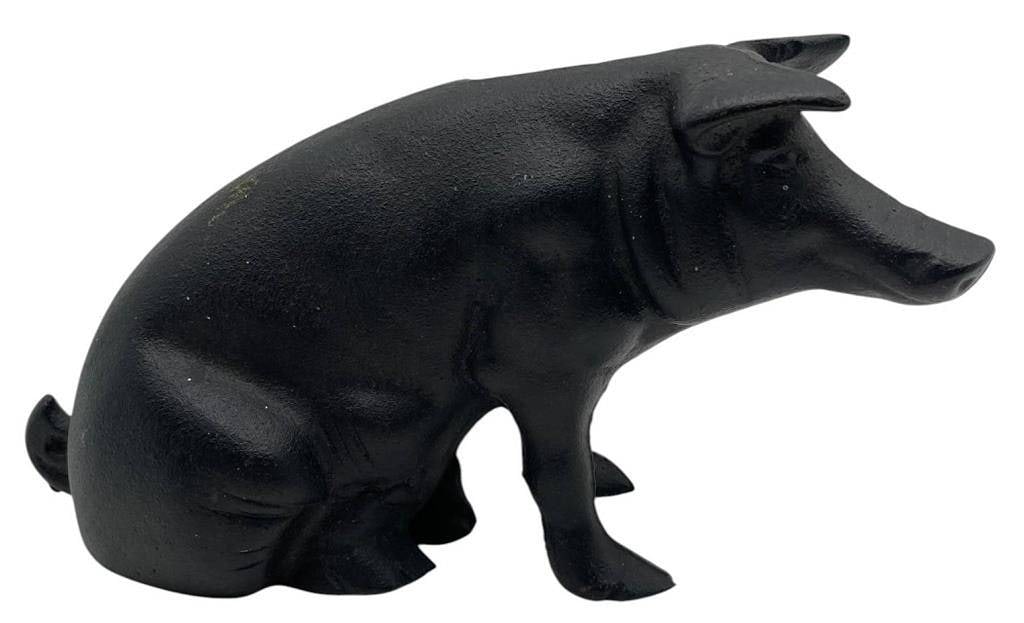 CAST IRON PIG BANK STILL BANK 9": Classic cast iron pig still bank with a matte black finish and traditional seated form. This decorative reproduction-style bank features a coin slot along the back and molded details including facial 