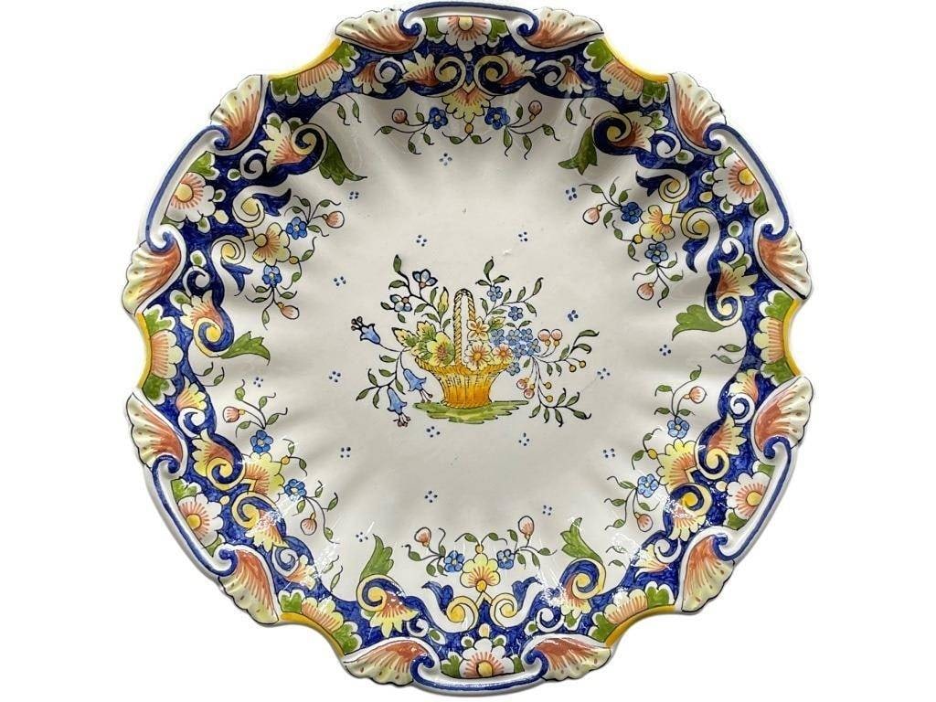 A. BRETON QUIMPER FRENCH FAIENCE WAAL PLATE: A. BRETON QUIMPER FRENCH FAIENCE FLORAL BASKET WALL PLATE | | | -Hand-painted French fa?ence wall plate by A. Breton, Quimper, featuring an elegant central motif of a flower-filled basket surrounded b