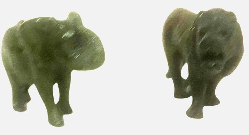 VINTAGE HAND-CARVED SOAPSTONE ELEPHANT AND LION: VINTAGE HAND-CARVED SOAPSTONE ELEPHANT AND LION FIGURES | | This pair of hand-carved soapstone figures features a detailed elephant and a roaring lion, each showcasing the natural weight and smooth fi