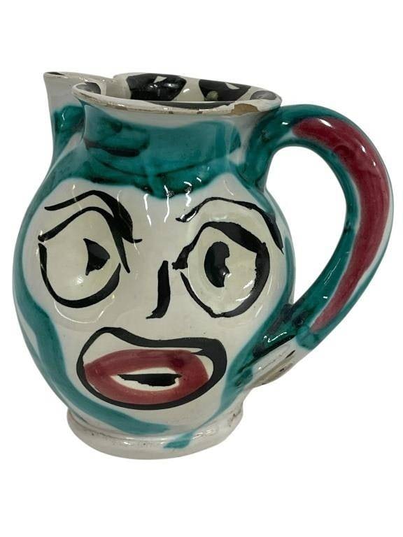 DECORATIVE SIGNED ABSTRACT FACE POTTERY PITCHER 4": DECORATIVE SIGNED ABSTRACT FACE POTTERY PITCHER 4" | -Good pre owned condition, chip near rim (see photos) | -Signed on bottom, illegible | -Approx 4"h x 4"w | -Playful and expressive hand-painted