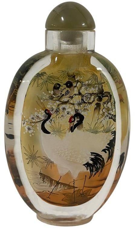 CHINESE REVERSE-PAINTED GLASS SNUFF BOTTLE: CHINESE REVERSE-PAINTED GLASS SNUFF BOTTLE | | This exquisite Chinese snuff bottle is a fine example of the intricate art of reverse painting on glass. The interior of the translucent glass bottle is 
