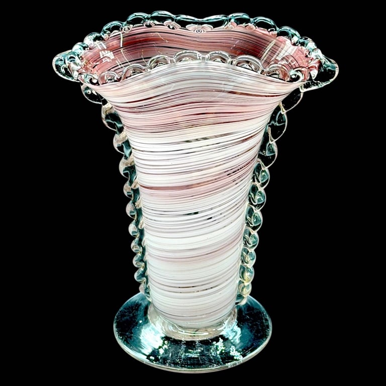 MURANO STYLE PINK SWIRL ART GLASS VASE 10": Unsigned art glass vase featuring fine pink and white swirling bands, a flared undulating mouth and clear applied glass ruffles along the rim and sides. The tapered body rests on a clear circular