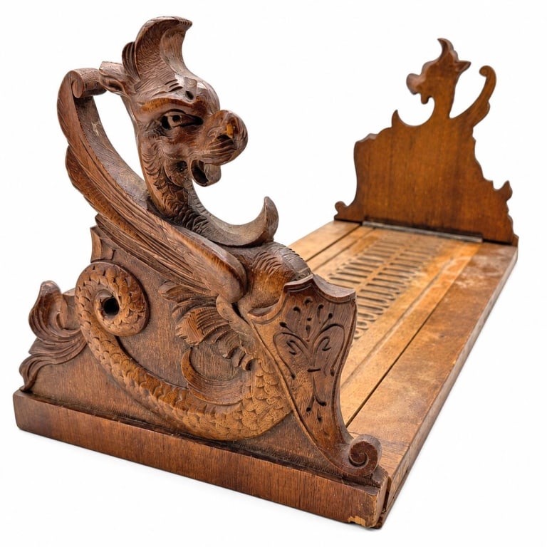 HAND CARVED DRAGON EXPANDING WOOD BOOK RACK 16": Decorative adjustable tabletop book rack featuring carved winged dragons with curled, scaled tails and shield motifs at both ends. Rich brown wood tones highlight the carved details, while the