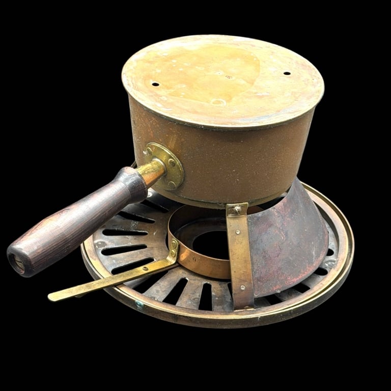 STERNO WARE ANTIQUE CHAFING STAND & POT 10": Vintage Sterno Ware copper and brass chafing-dish warming stand with wooden handle, circular slotted platform, curved supports, and handled fuel holder. The wide platform supports a separate cooking p