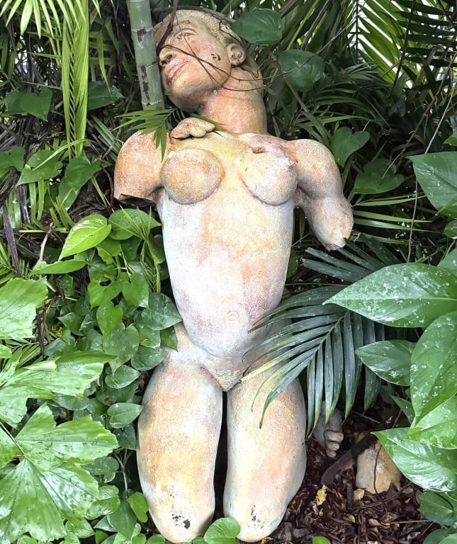FEMALE TERRA COTTA GARDEN SCULPTURE 51": Female garden sculpture featuring an expressively tilted head, swept-back hair, elongated torso and rounded thighs. Sculpted facial features and gently turned shoulders lend the figure a contemplative