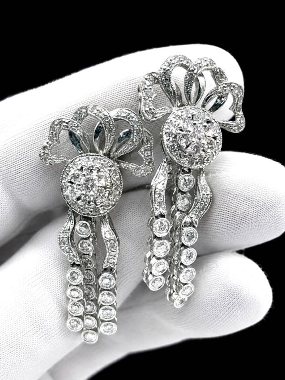 DIAMOND DANGLE DROP EARRINGS 8.7 GRAMS: DIAMOND DROP EARRINGS IN JEWELRY BOX | | Elegant pair of estate drop earrings featuring brilliant white stones arranged in graduated articulated settings for exceptional movement and sparkle. The earr