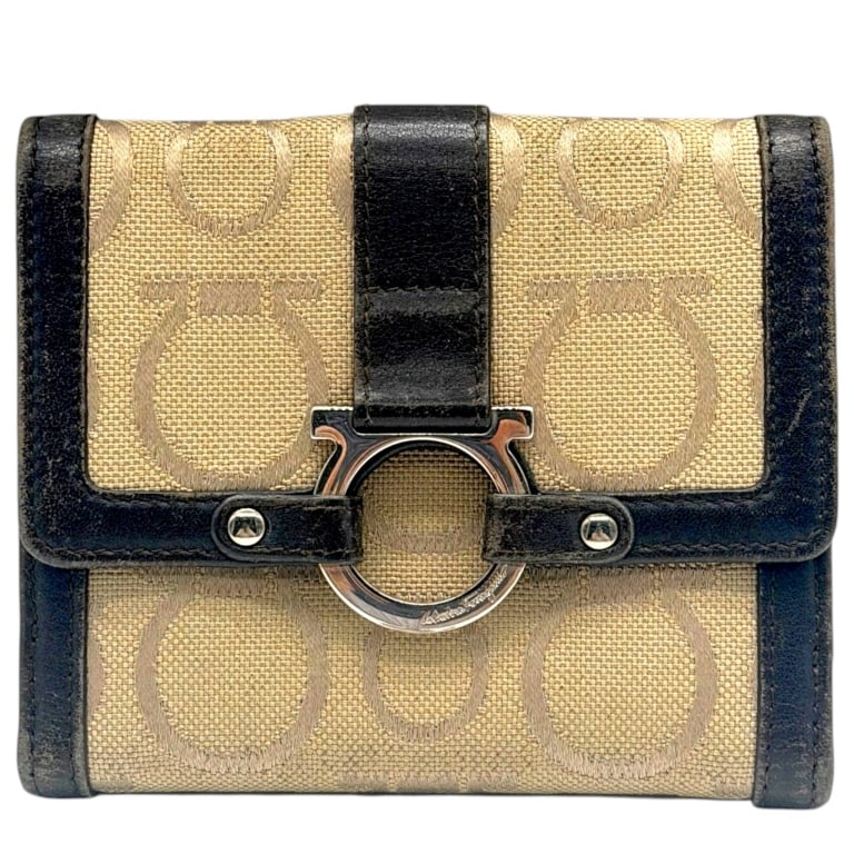 SALVATORE FERRAGAMO GANCINI WALLET 5": Vintage Salvatore Ferragamo compact bifold wallet crafted in beige woven monogram canvas with dark brown leather trim and polished silver-tone Gancini hardware. The front features the iconic oversized
