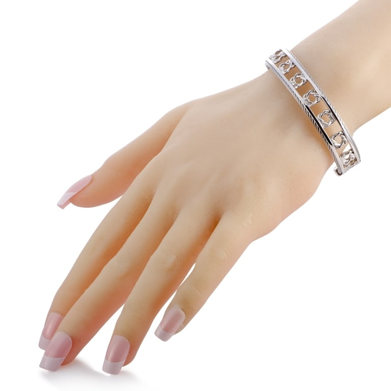 CHARRIOL HEART TO HEART STERLING SILVER BANGLE BRA: The Charriol Heart to Heart bracelet is crafted from sterling silver and weighs 25.2 grams, measuring 7.85 in length and 2.50 in diameter.This jewelry piece is offered in brand new condition and inclu