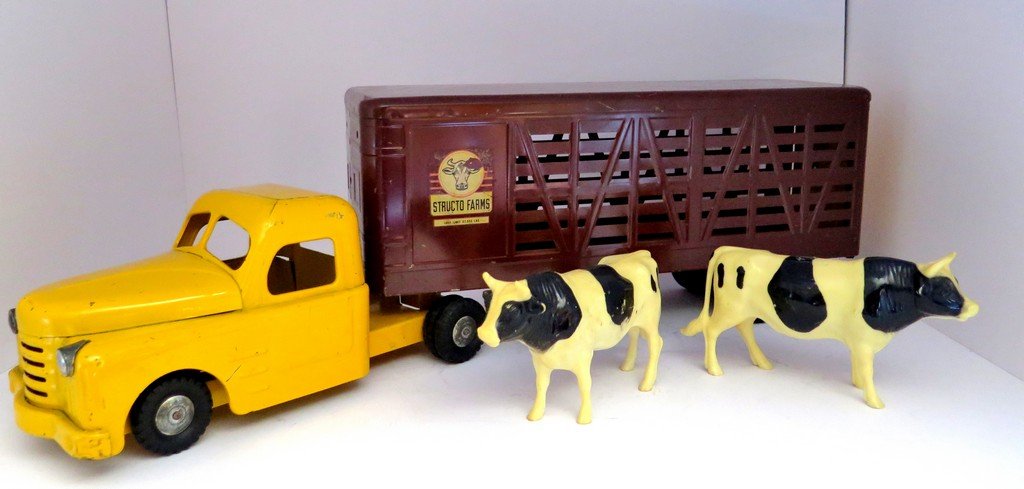 Vintage Cattle Bull Hauler Truck and Trailer Structo: Vintage Cattle Bull Hauler Truck and Trailer Structo Farms Toys with two Toy Bulls brown with yellow doors and yellow ramp good paint with surface wear and scratches normal fifth wheel dually 28” lo