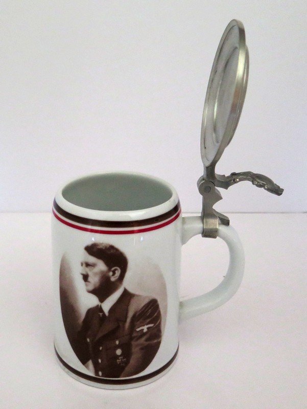 Ca. 1930’s Hitler Campaign Stein with Lid – German: Ca. 1930’s Hitler Campaign Stein with Lid – German Writing on Lid Translates to “ One People, One Land One Leader” – Mobile Swastika with Eagle (Teutonic Symbol) on Base – Marked on Base D