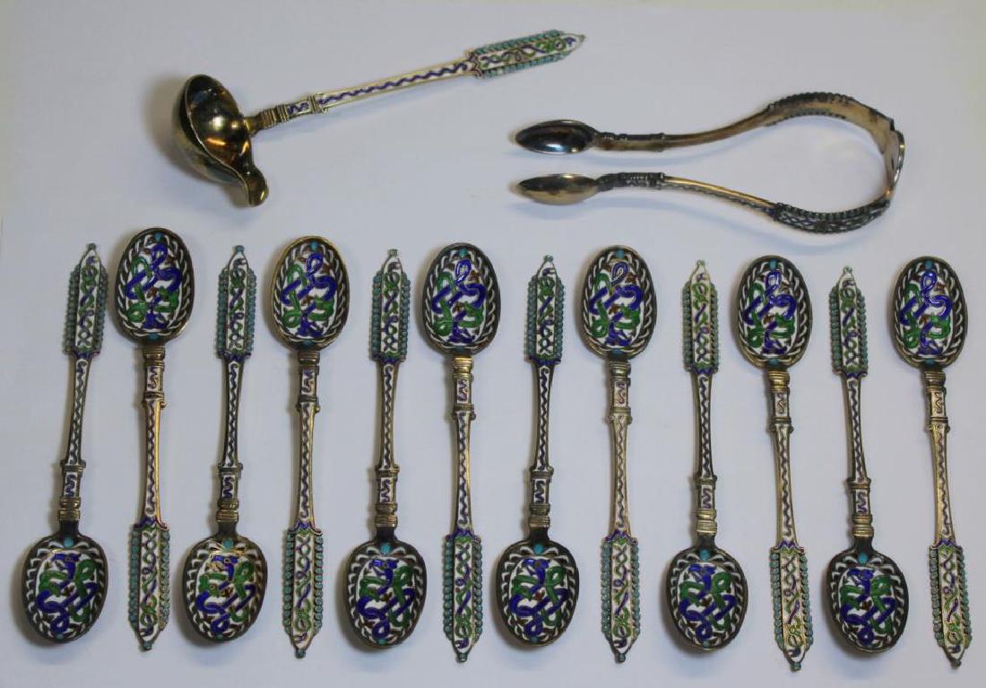 SILVER. 924 Silver Gilt and Enamel Coffee or Tea: Set. Includes twelve 924 silver gilt and enamel decorated demitasse spoons, sugar tongs, and a cream ladle. Beautiful green, white, and blue enamel decoration of intertwined snakes to all items. Each