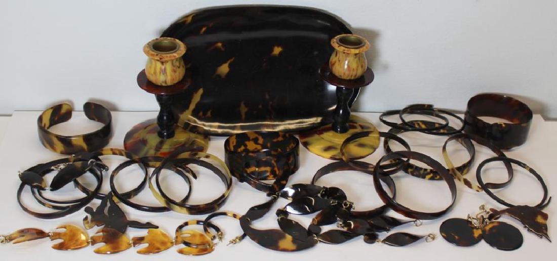 JEWELRY. Assorted Grouping of Tortoise? Shell: Jewelry and Decorative Items. Jewelry includes 17 bracelets/bangles; 2 pendant link bracelets; a pendant link necklace; 2 brooches; a pair of hoop form earrings; and a pair of round pendant earrings.