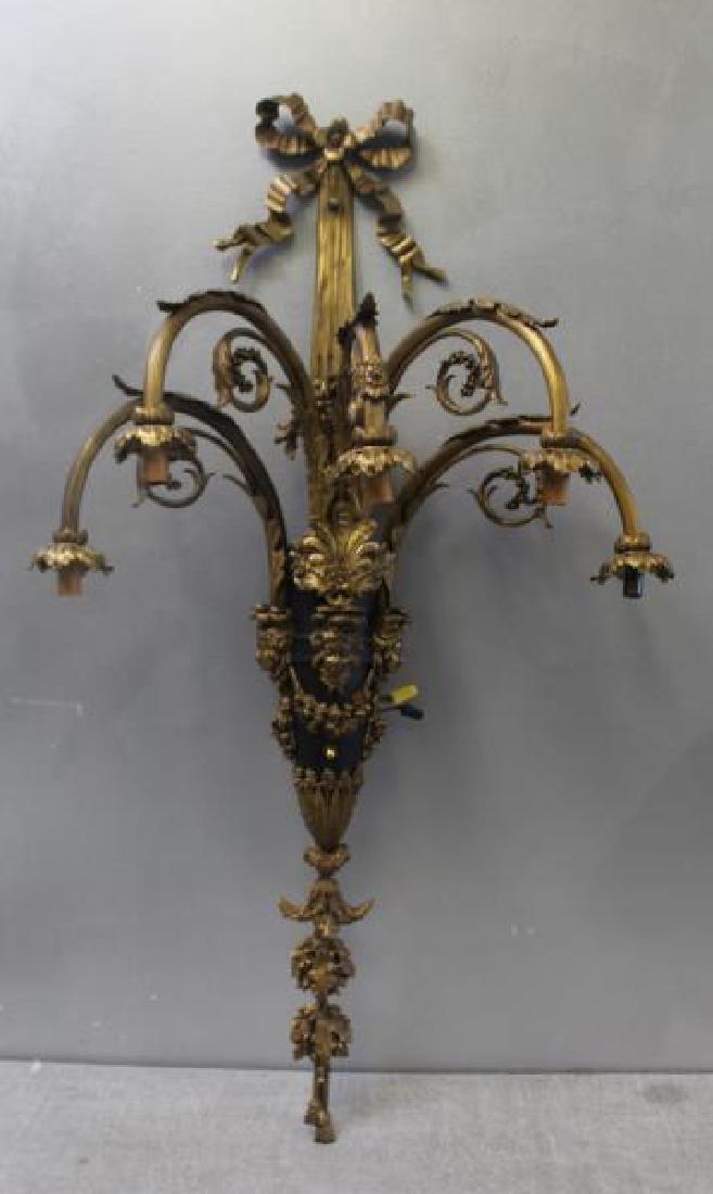 Large and Impressive Bronze Patinated Sconce.: With Lady Heads, Ribbon and Tassel Design. From a Scarsdale, NY estate. Dimensions: 23" w x 40" h.