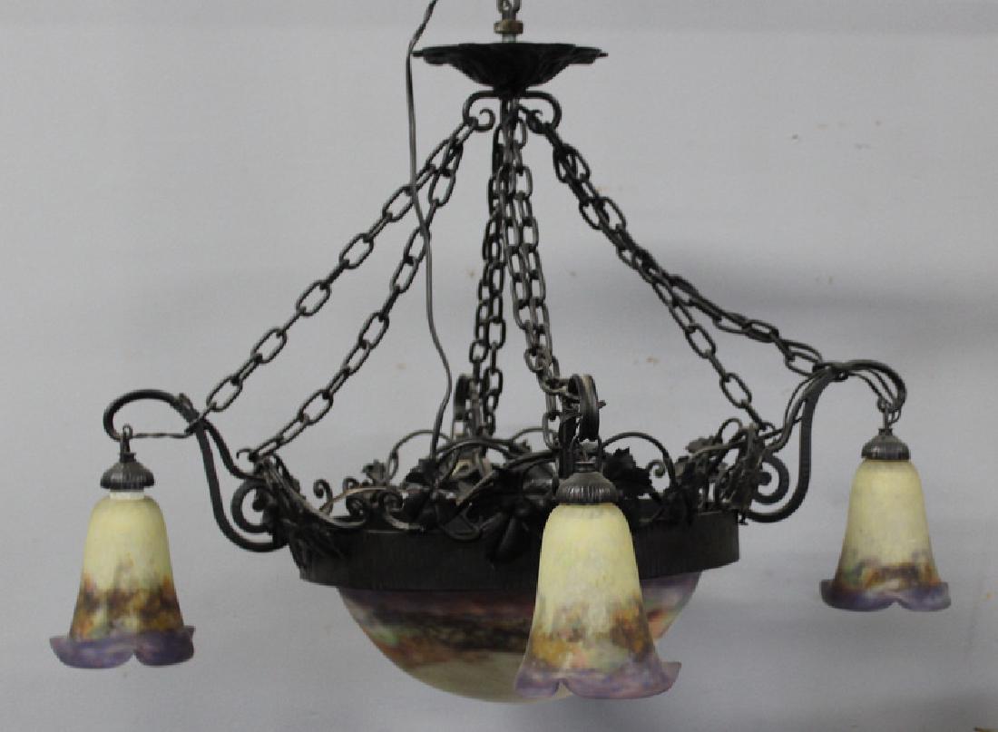 Art Nouveau Luneville Art Glass & Iron Chandelier: The central shade and 4 smaller shades signed Muller Freres, Luneville. All within a wrought iron mount. From a Larchmont, NY estate. Dimensions: 20" w x 20" d x 22" h.