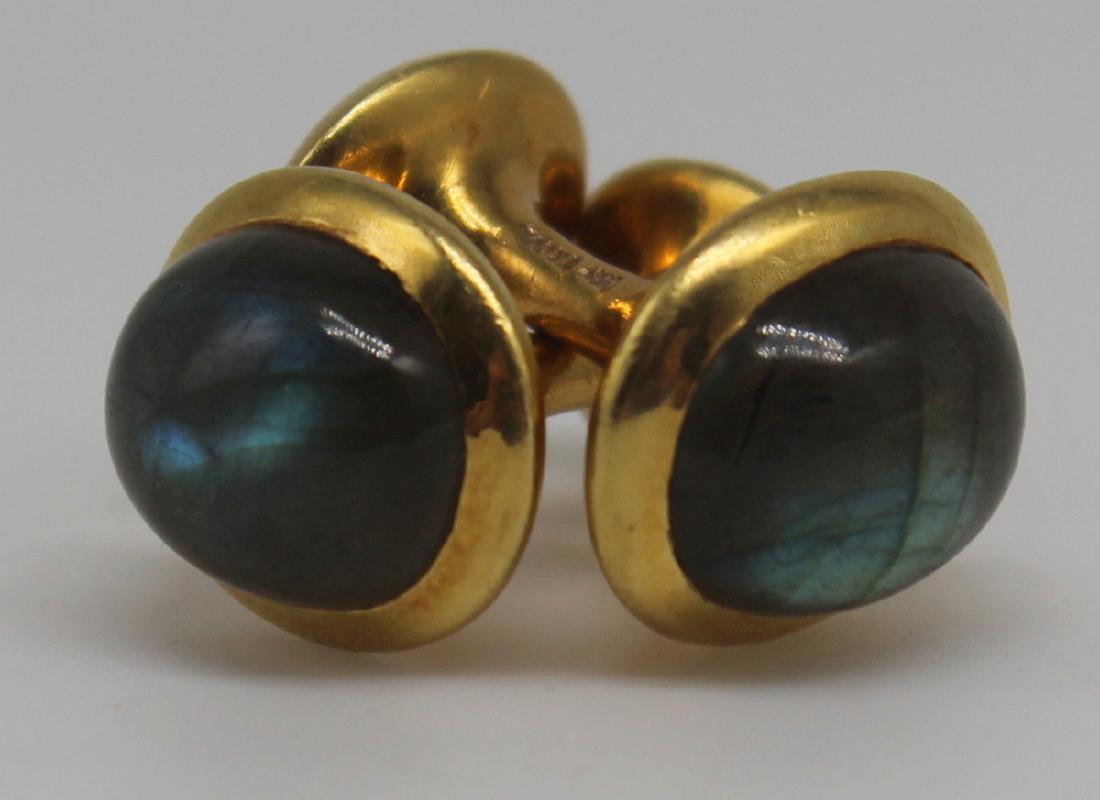 JEWELRY. Pair of Tiffany & Co. Labradorite and: 18kt Gold Cufflinks. Pair of Tiffany & Co. 18kt yellow gold and oval labradorite cufflinks. Labradorite cabochons measure approx. 11.5mm x 10mm. Stamped, "T&Co. 18k". Accompanied by a copy of a Tiffan