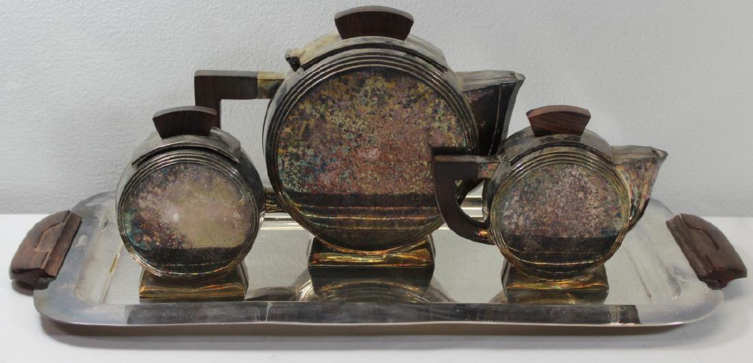 SILVER-PLATED. Escapade Art Deco Inspired Tea Set.: French Escapade 3 pc. Art Deco inspired tea service including a teapot, creamer, sugar, and serving tray. With wooden finials to hollow ware, and wooden handles to serving tray. Each item with, "