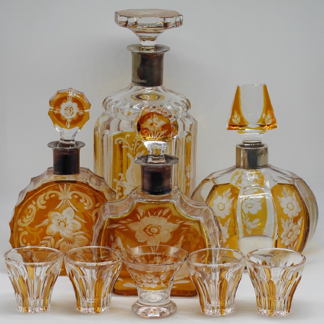 SILVER. .835 Silver Mounted Decanter Grouping.: Includes (4) 0.835 silver mounted cut to clear etched glass decanters - each stamped 835S to neck of each decanter. Accompanied by (4) Bohemian glass cordials, and (1) cut to clear etched cordial glas