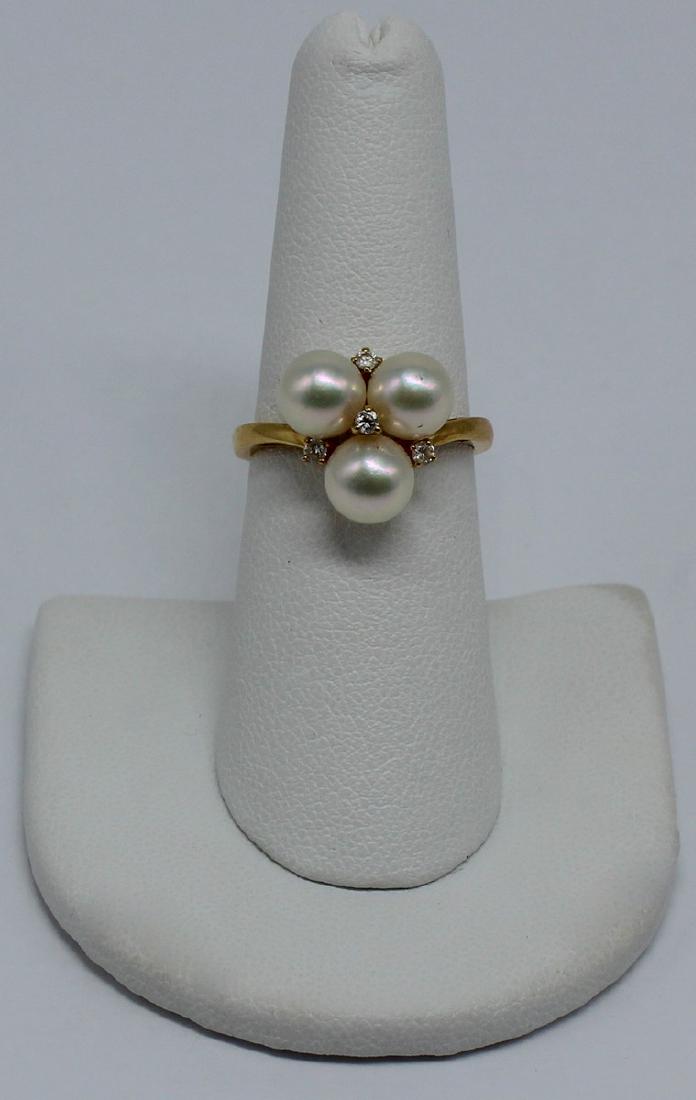 JEWELRY. Mikimoto 18kt Gold, Pearl, and Diamond: Ring. Includes a Mikimoto 18kt yellow gold ring set with (3) pearls and (4) diamond accents. Pearls measure approx. 6.5mm each, and diamonds measure approx. 1.5mm or .015cts each. Stamped, "750&q