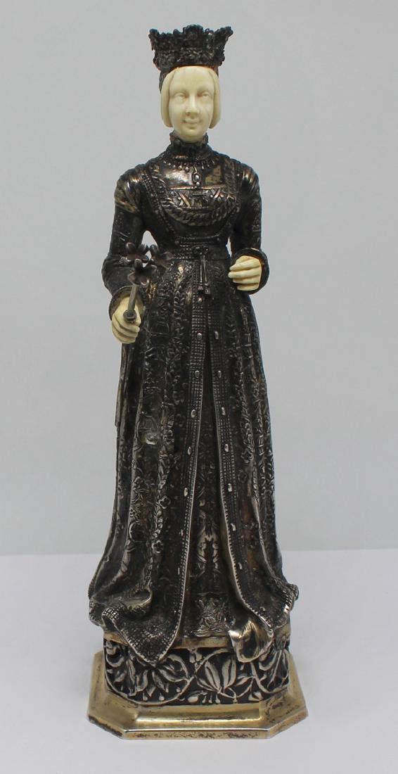 SILVER. Ludwig Neresheimer .800 Silver Cabinet: Figure of a Queen. Late 19th, early 20th century German .800 silver cabinet figure depicting a queen with carved hands and face; grasping a scepter with floral finial. On an octagonal plinth base. Sta