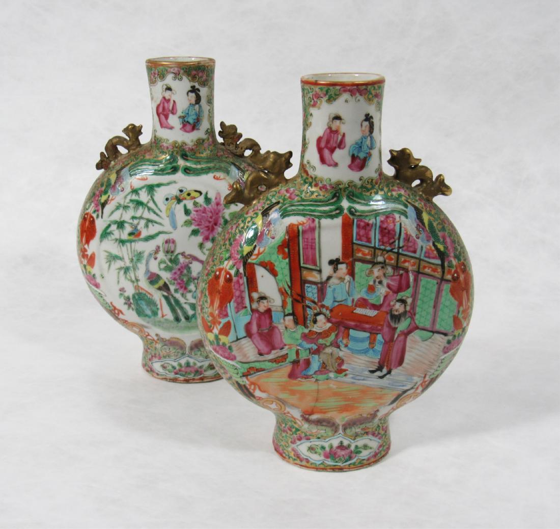 Pair of Small Rose Medallion Moon Flasks.: Of typical form, one side painted with gentlemen and ladies, the other with birds and flowers, each with gilt dragon-form handles to shoulders. From a New City, NY estate. - Dimensions: 9.75" h x 7" w