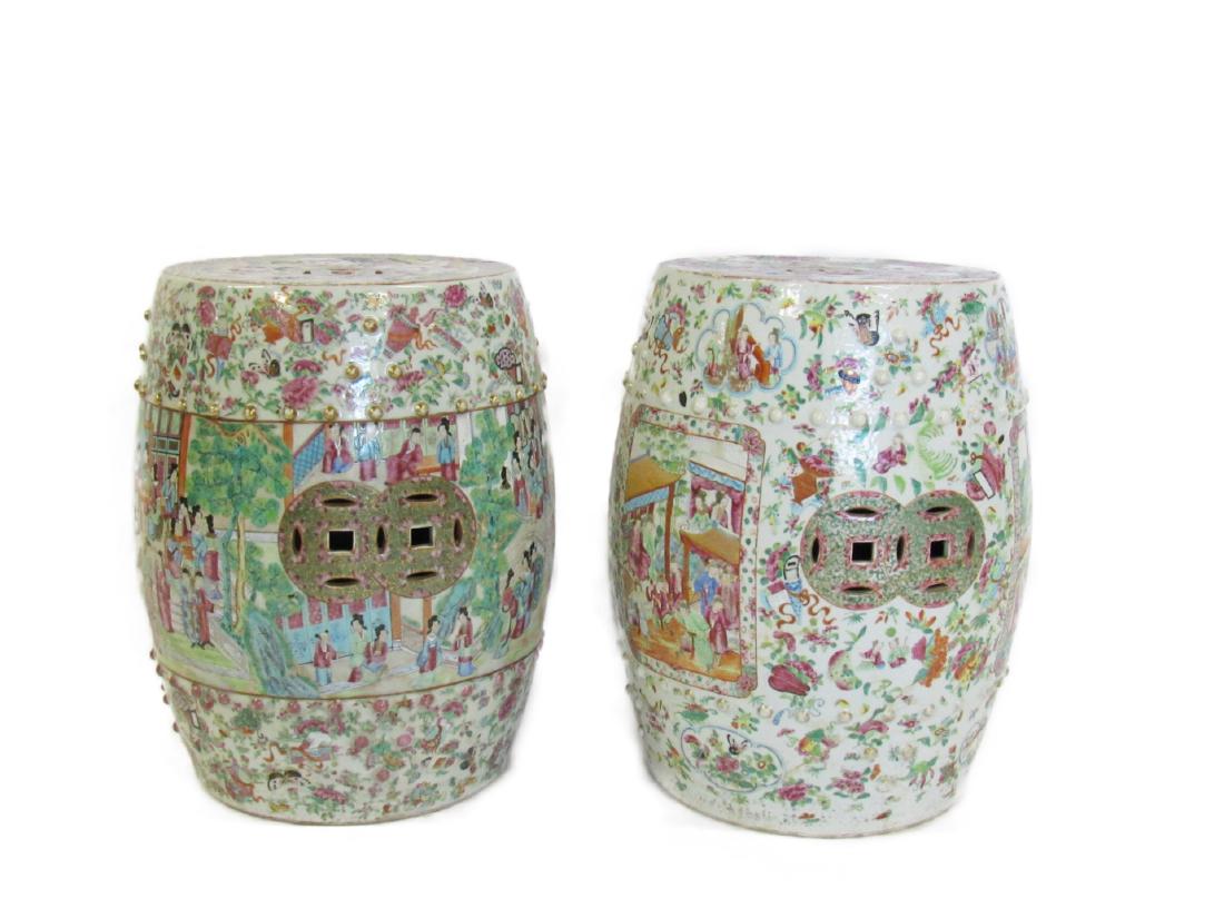 A Near Pair of Rose Medallion Garden Stools.: One with a continuous band depicting ladies and gentlemen in a courtyard, the other with figural panels surrounded by patterns of birds, butterflies, and flowers. Both flanked top and bottom with two 