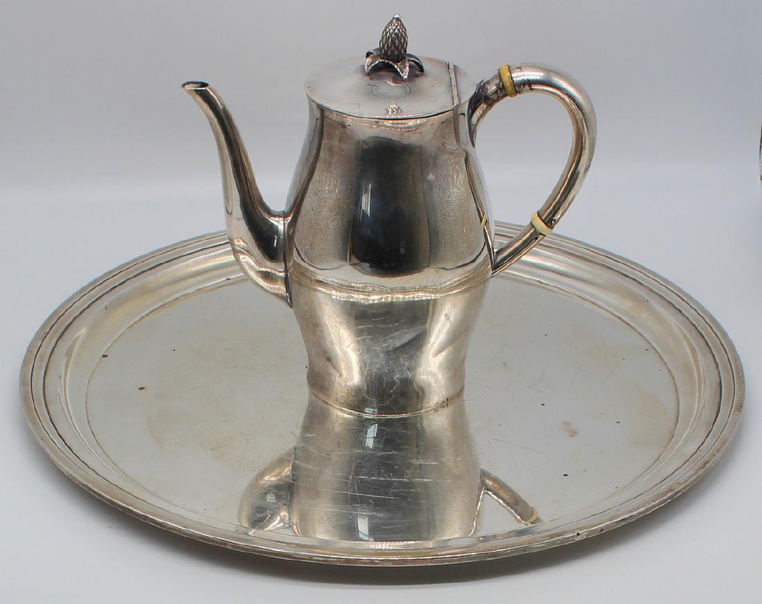 STERLING. Grouping of Misc. American Sterling.: Includes a Tiffany & Co. sterling charger with central monogram; and a Tuttle Paul Revere pattern coffee pot with acorn finial - retailed by J.E. Caldwell & Co. Total approx. weight of two ite