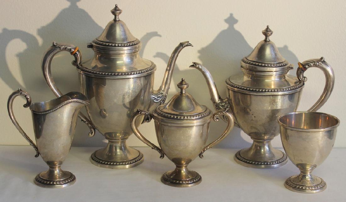 STERLING. 5 Pc. Amston Sterling Tea Service.: Includes an Amston sterling tea service comprised of a teapot, coffee pot, lidded sugar, creamer, and open waste vessel. Stamped to underside, "Amston Sterling 810". Total approx. weight is 