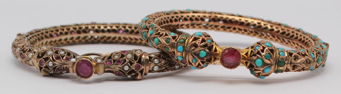 JEWELRY. (2) Mughal Gem-Set Gold Hinged Bracelets.: Includes an Indian Mughal style 10kt yellow gold bracelet inlaid with faceted rubies and blue cabochons, possibly turquoise. Stamped to underside of closure, "India 10kt". Accompanied by a s