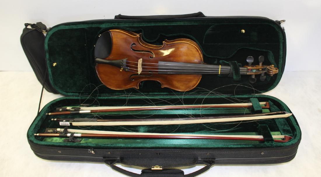 After Stradivarius Violin And 3 Bows .: Owned by Paul Cadmus and the Collection of John F. Anderson. 1 bow signed Atelier and 1 signed Vio. - Dimensions: 9" x 23" L Case: 30" x 10.5" x 5" h