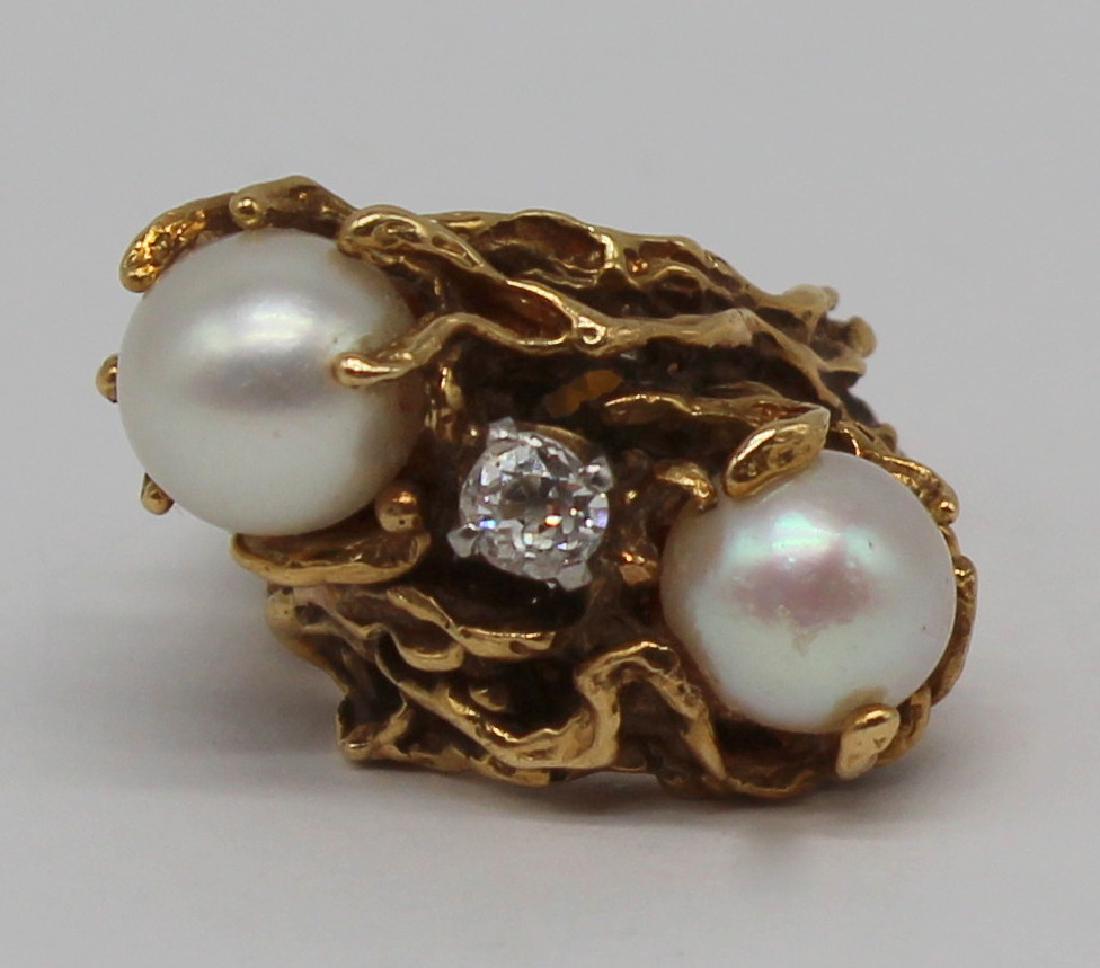 JEWELRY. Signed 18kt Gold, Pearl and Diamond Ring.: Signed 18kt yellow gold modernist ring with a central Old Mine cut diamond flanked by (1) cultured pearls forming a diagonal line. Old Mine cut diamond measures approx. 3.8mm or approx. 0.20cts; pearl