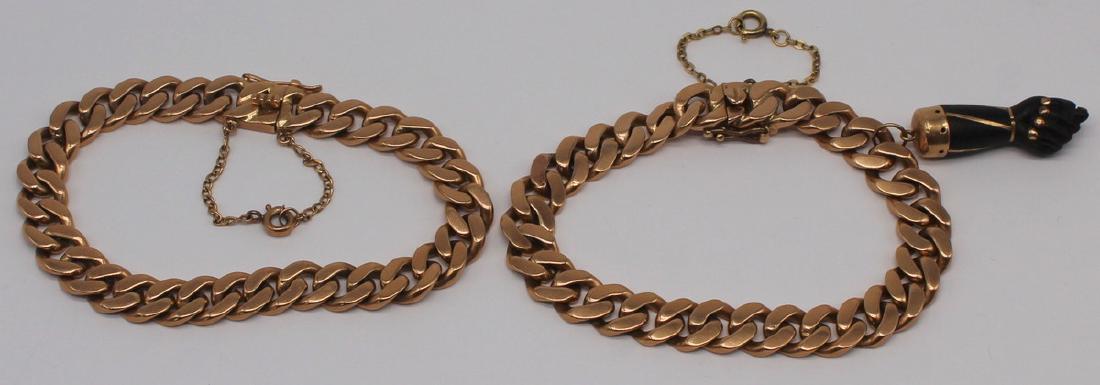 JEWELRY. Pair of 18kt Gold Flat Curb Bracelets.: Pair of 18kt rose gold flat curb link chain bracelets. One with gold mounted ebonized wood figa charm. Both bracelets stamped, "18k". Total approx. weight of both bracelets and charm is 50.4 dwt. From