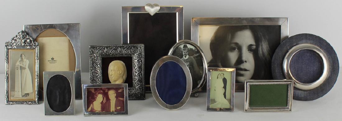 SILVER. Group of 12 Frames Inc. Vera Wang.: Includes a Vera Wang rectangular sterling frame with heart border to side and applied ribbed heart; a small rectangular sterling frame; an English silver rectangular frame - Mappin & Webb; an Inte