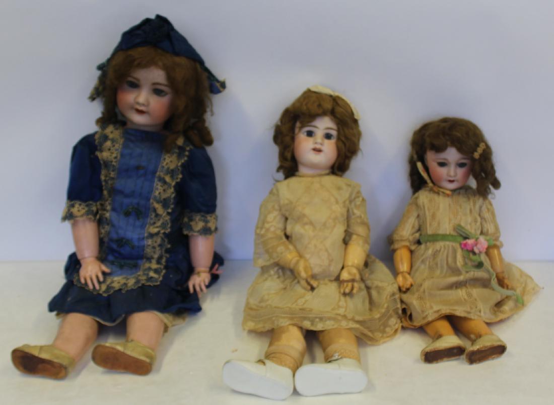 3 Antique Bisque Head Dolls Inc Jumeau: The doll in blue outfit approx 29"H , doll with ribbon approx 26"H and Jumeau approx 23"H. From a Forest Hills Queens estate .