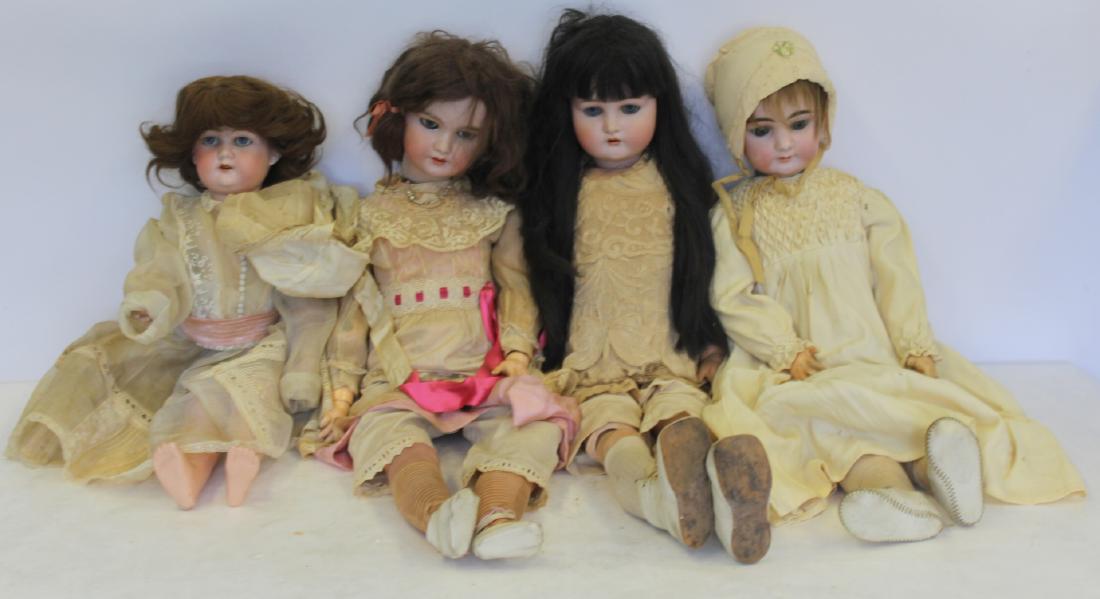 4 Antique German Bisque Head Dolls: To include one Florodera made in Germany, blue eyed, brown hair with bonnet. Chips, crack on back (21" h), one Kämmer & Reinhardt with Star of David hallmark with long black hair and blu