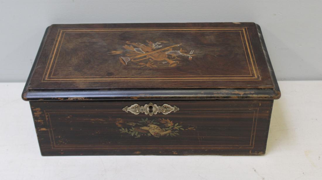 Antique Inlaid 8 Tune Music Box: With violin and trumpet inlay motif. From an Upper East Side NYC collector. - Dimensions: 19" x 10.5" x 7" h