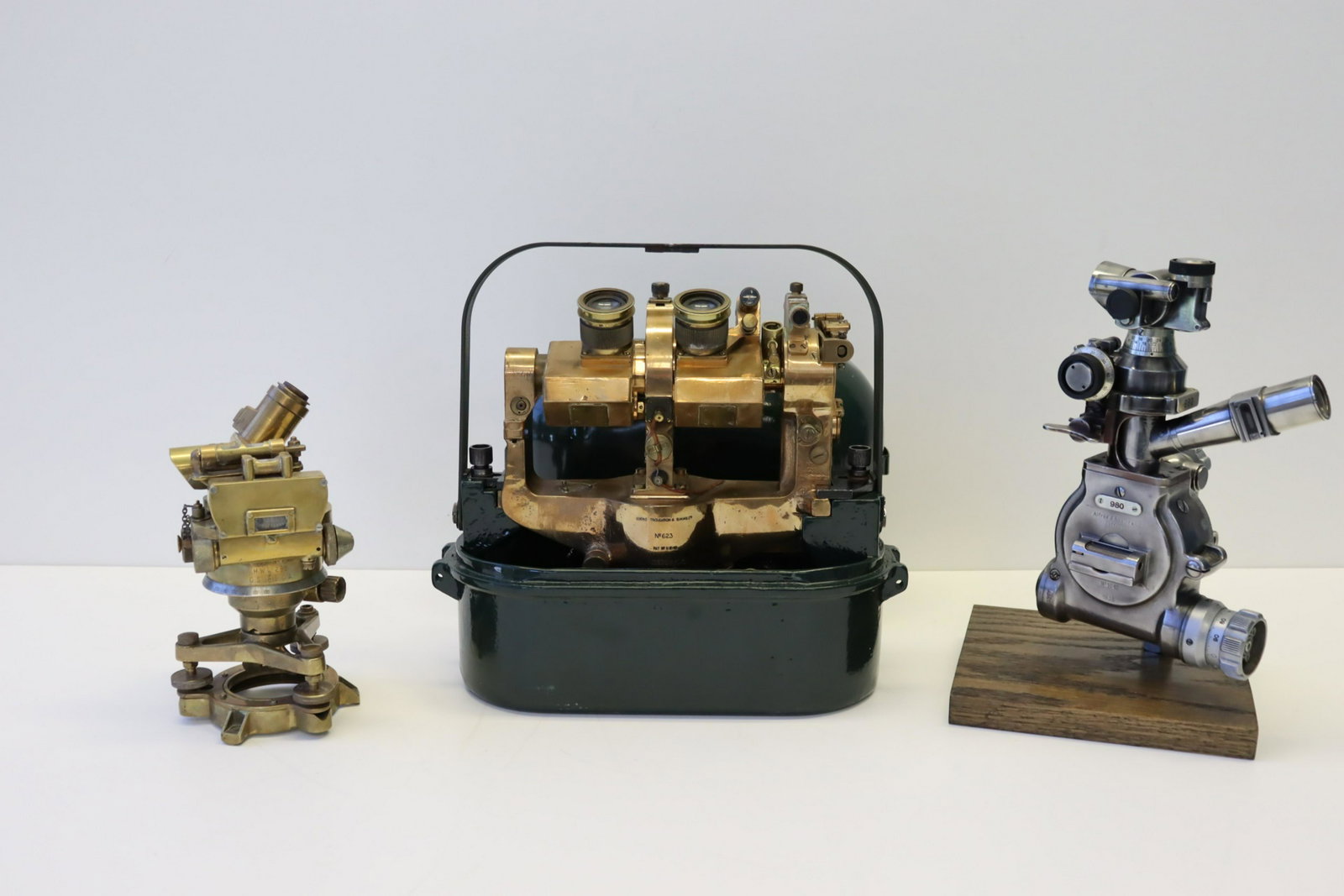 Three (3) Optical / Surveying Instruments: Alfred J. Amsler & Co., Model 980, 1935, chrome finish, on stand, (with) "Director No. 7 MkV", brass, "H.W.C. 268/O.S. 1815 G.A.", (with) a cased "Cooke Troughton & Si