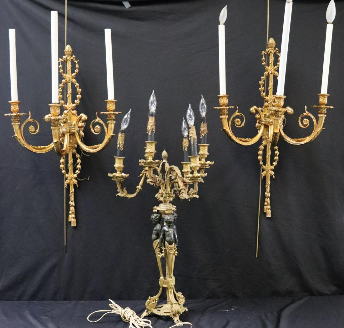 Antique Bronze Lighting Grouping .: To inc 2 sconces and a figural lamp.From a Westchester estate .Measurements are Candelabra 29"h x 15"w Sconces : 27"h x 16"w