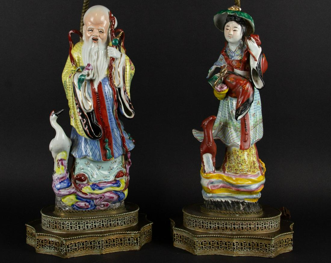 A Pair of Porcelain Immortals Mounted as Lamps.: Chinese, 20th century. A figure of Shoulao with a crane, together with a figure of Magu with a deer. From a Larchmont, NY estate. Dimensions: figures 14" h x 6.25" dia., overall 30" h.