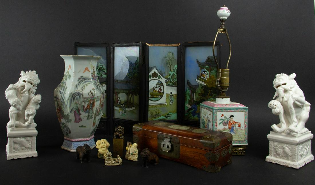 Grouping of Asian Items.: Including two blanc-de-chine buddhist lions, a small painted glass table screen, a famille rose hexagonal vase, a stone and metal inset box, several resin and wood carvings, and a famille rose lozenge