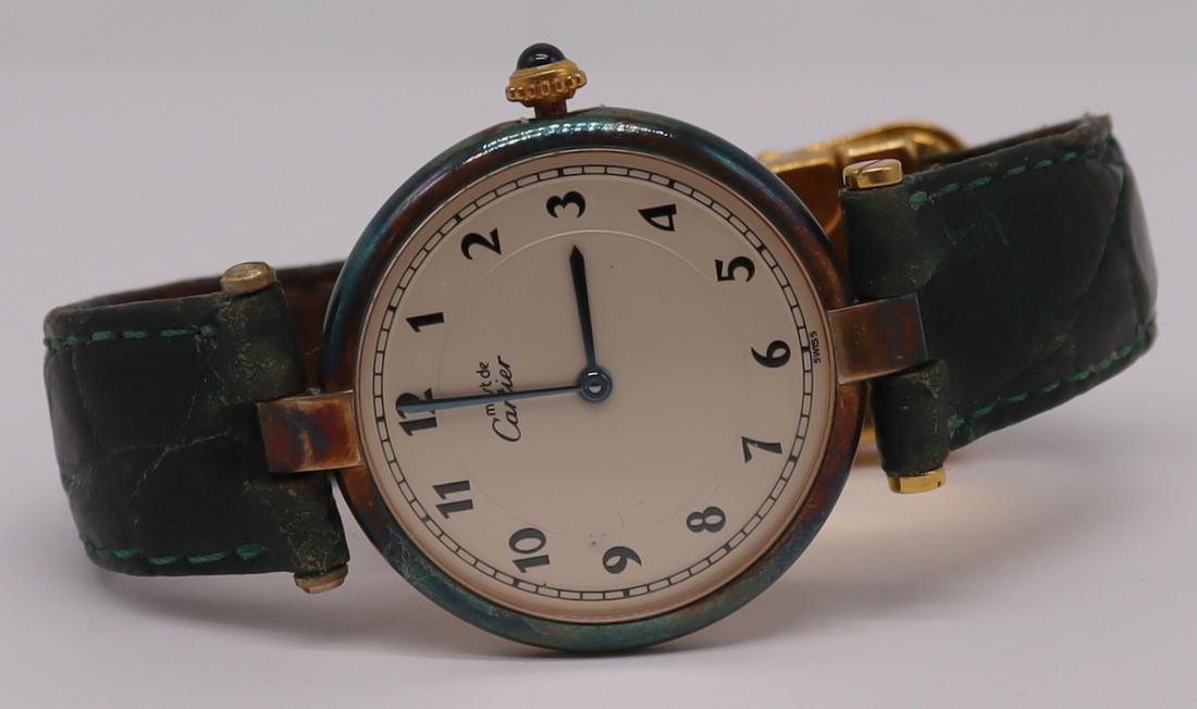 JEWELRY. Must de Cartier Vermeil Sterling Watch.: Ladies Must de Cartier vermeil sterling watch face with original Cartier watch band and hardware. No. 026500 590003. With a Cartier Quartz movement, 7 jewels. From a Harrison, NY estate.