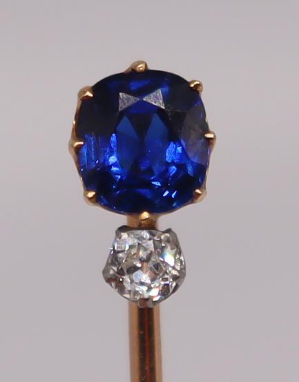 JEWELRY. Tiffany & Co Sapphire and Diamond Stick: Pin. Tiffany & Co.18kt yellow gold stick pin with a cushion cut sapphire prong set above an Old European cut diamond. Sapphire measures approx. 5.5mm x 5.0mm; diamond measures approx. 2.5mm. Stamp