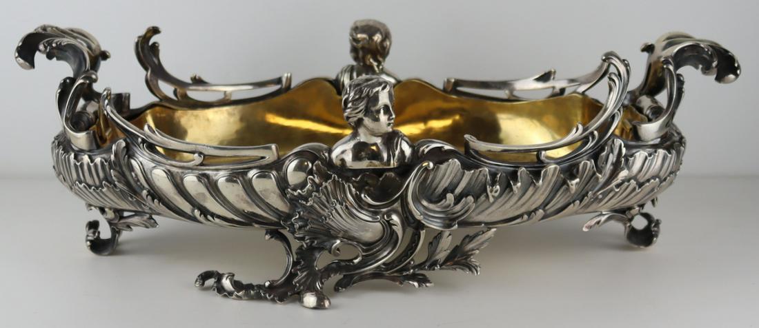 SILVER. French Alphonse Debain Silver Planter.: French Signed Alphonse Debain .950 silver planter with scroll details and applied cherub heads. Accompanied by a fitted brass liner. Stamped to underside of planter with a diamond form frame of AD fla