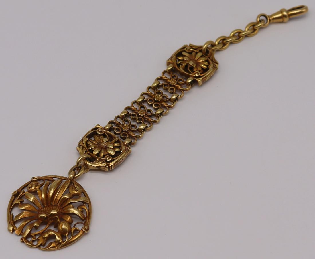 JEWELRY. 18kt Gold Floral Decorated Chatelaine.: 18kt yellow gold chatelaine with floral decoration and an openwork sunflower charm. Apparently unmarked. Total approx. weight is 19.5 dwt. From an E 86th St, Manhattan estate. Dimensions:1.12" w 