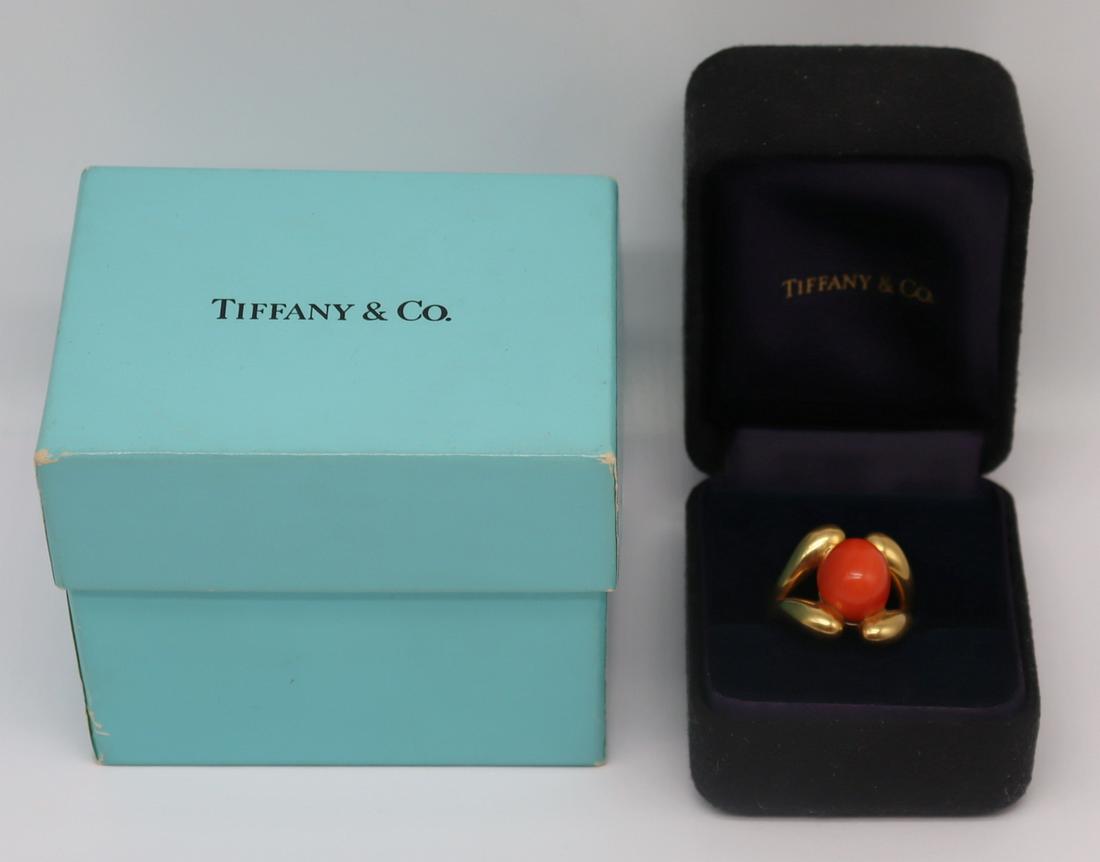 JEWELRY. Schlumberger for Tiffany 18kt Gold and: Coral Ring. Schlumberger for Tiffany & Co 18kt yellow gold cocktail ring set with a single oval form coral cabochon. Split shoulder design. Coral cabochon measures approx. 11.0mm x 13.0mm. Stamped