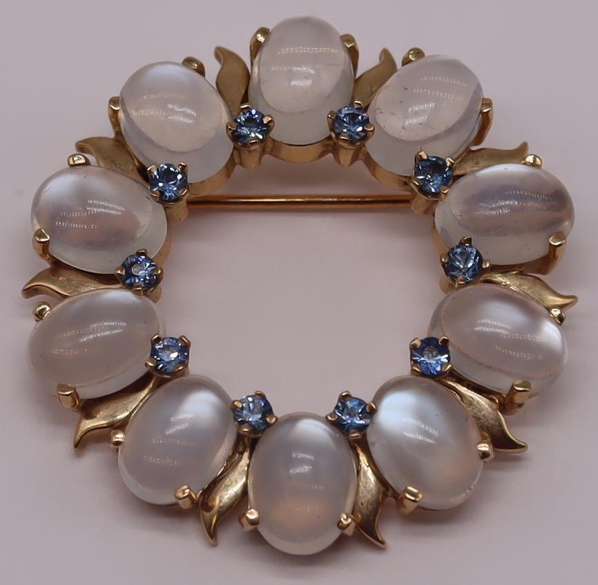 JEWELRY Tiffany & Co. Moonstone & Sapphire: Tiffany & Co. 14kt yellow gold wreath form brooch comprised of (10) oval cut moonstones and (10) round faceted sapphires. Moonstones measure approx. 6.0mm x 8.0mm; sapphires measure approx. 2.0mm