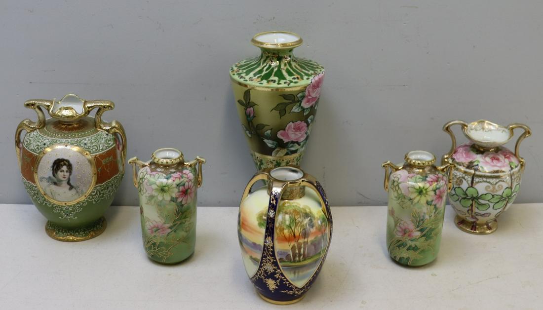 Nippon. Grouping Of 6 Japanese Porcelain Vases.: To include a pair of floral vases (7.75" h), two-handled floral vase (8.25" h), tall floral vase (14.5"), one vase with a portrait of a lady (10" h) and one vase with a landscape scenery (8.25" h). Al